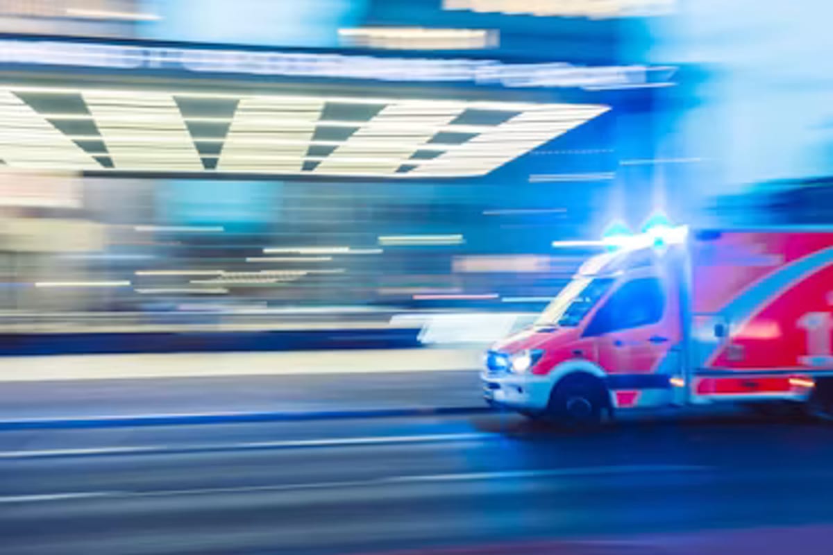 An emergency response vehicle travelling with lights on